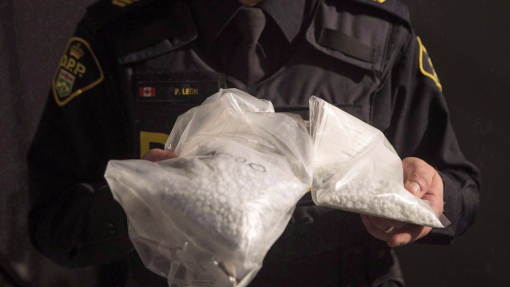 An OPP officer displays bags containing fentanyl as Ontario Provincial Police host a news conference in Vaughan, Ont., on February 23, 2017. (THE CANADIAN PRESS/Chris Young)