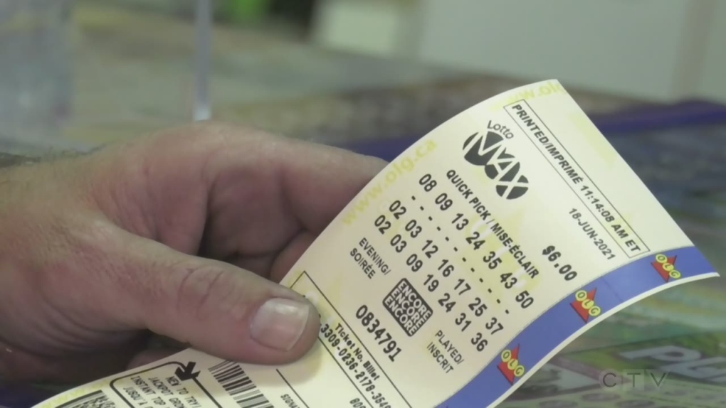 A man holds a Lotto Max ticket in his hand in Barrie, Ont. on Fri. June 18, 2021 (Katelyn Wilson/CTV News)