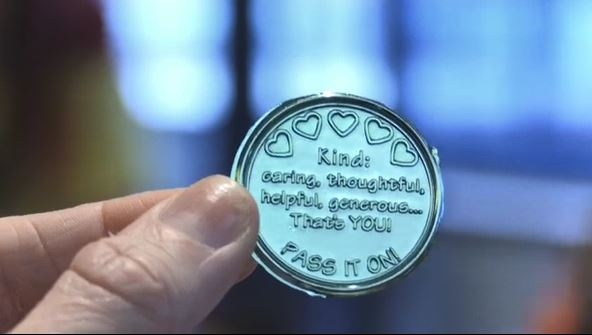 Kindness ninjas hand out coins to college students