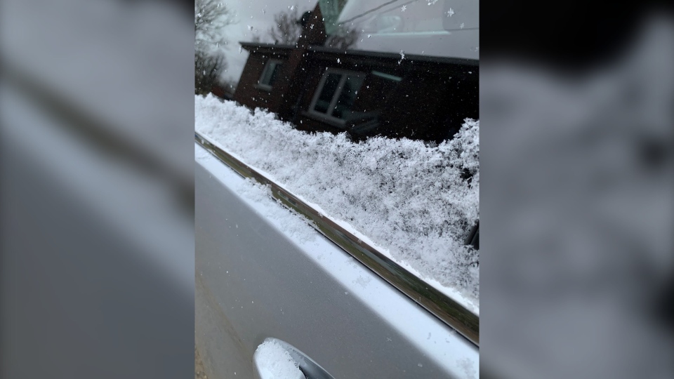 A light dusting of snow on a car