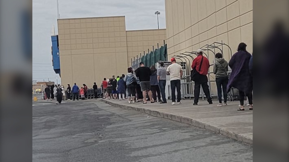 Customers lineup outside Walmart in Sudbury, Ont.